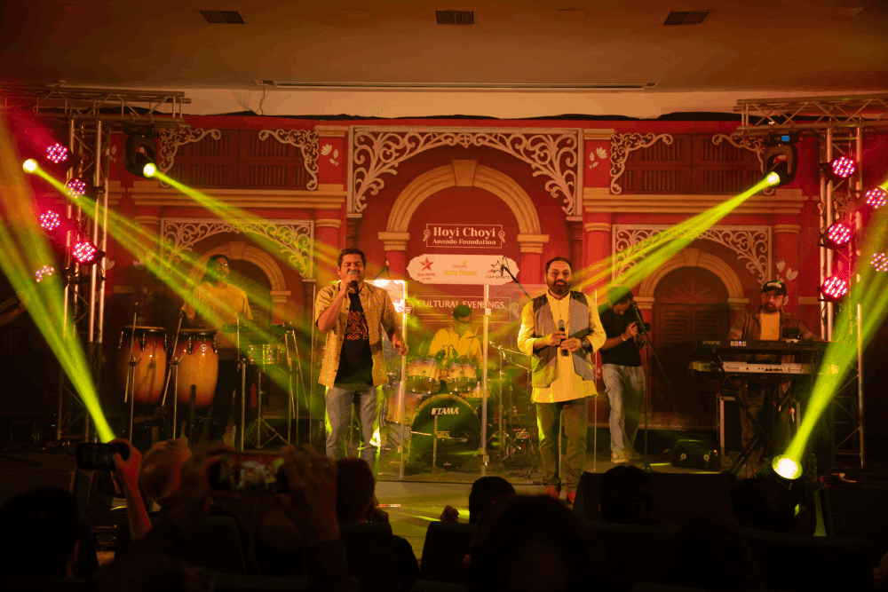Singers performing on stage at HCAF Gala Evening with colorful stage lighting